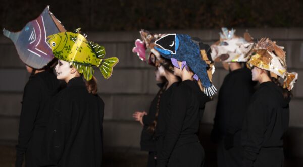 Performers wearing fish hat puppets (hats by artists Maggie Arbeiter and Patty Gille). BareBones Extravaganza 2022. Photo by Paul Irmiter.
