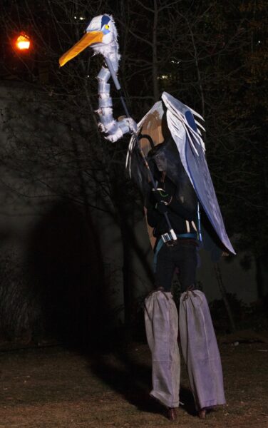 Crane puppet (by artist/volunteer Saul Silberman) being stilted during a performance. BareBones Extravaganza 2022. Photo by Paul Irmiter.
