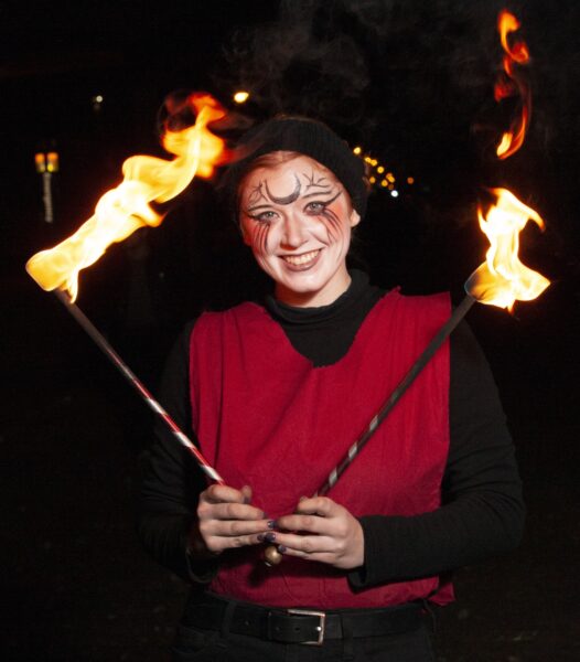 Fire performer Annabelle Daily posing for a portrait pre-show. BareBones Extravaganza 2022. Photo by Paul Irmiter.