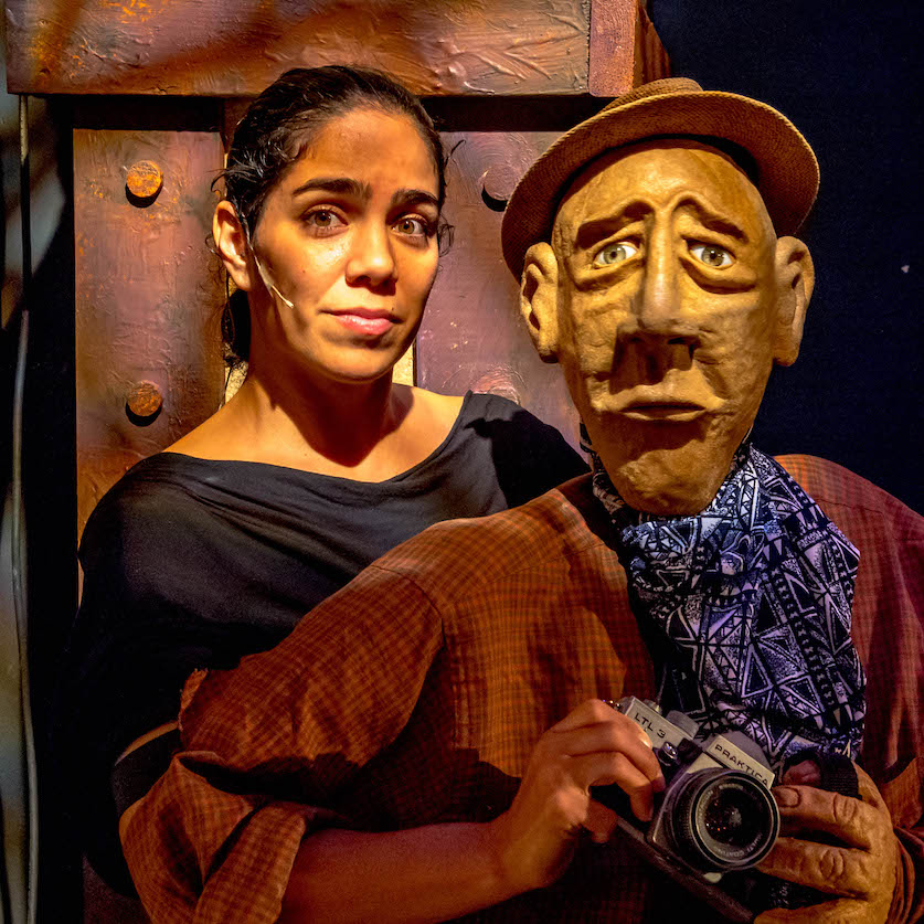 Sofia Padilla posing with a puppet of an old man.